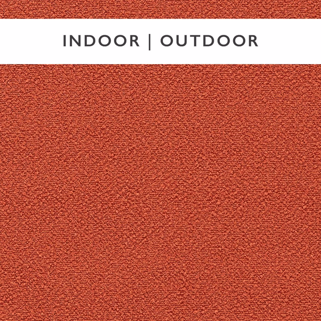 Close-up of muted rhubarb-red outdoor fabric with dense pebbled woven texture
