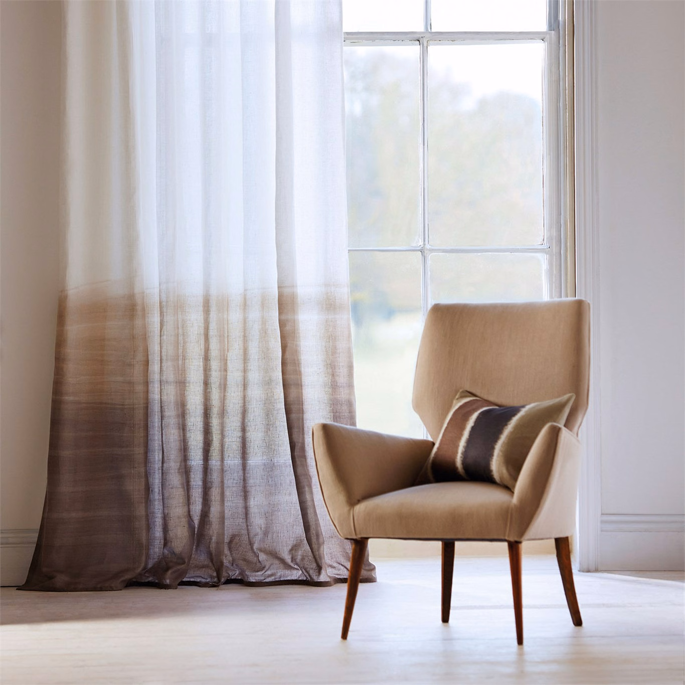 Sheer curtain fading from pale ivory to taupe-brown with fine vertical striations