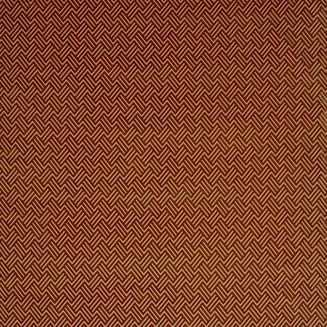Dense burnt umber woven fabric with fine rust chevrons in a compact geometric pattern