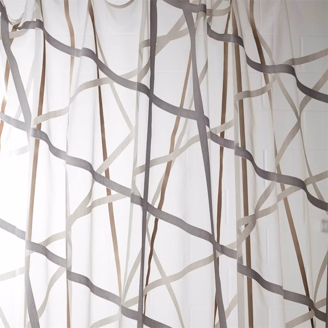 Ivory sheer with intersecting graphite and bronze linear trails