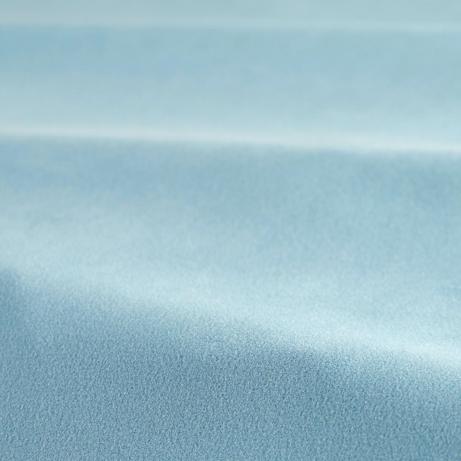 Close-up of soft aqua teal velvet showing fine pile and broad directional sheen