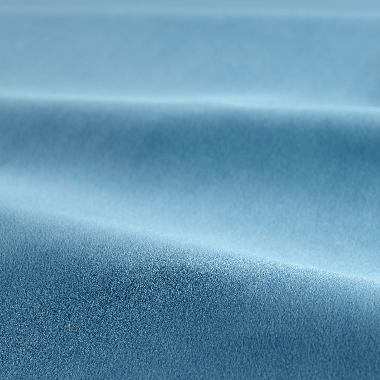 Close view of cool teal-blue velvet with smooth pile and soft reflective bands