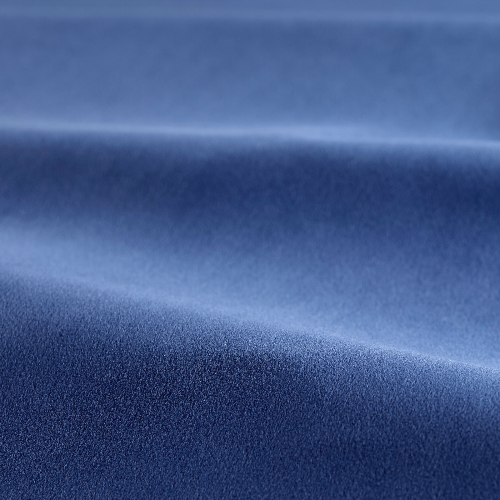 Deep azure-blue velvet showing soft pile and luminous highlights across folded fabric