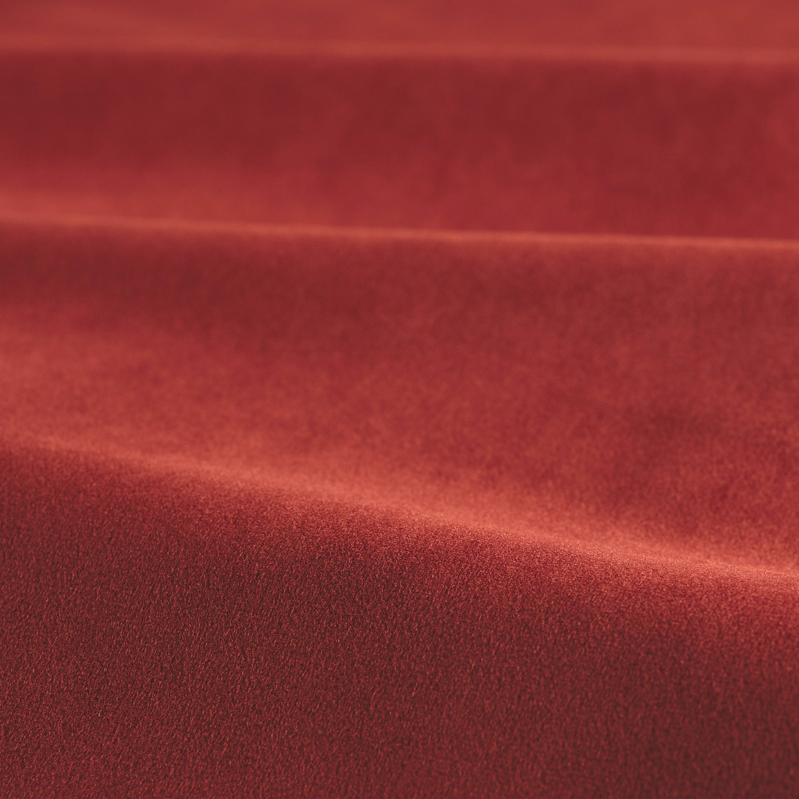 Deep carnelian red velvet swatch showing a soft pile and directional sheen