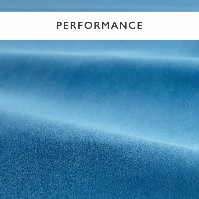 Cool cornflower-blue velvet showing soft pile, directional sheen and folded tonal shading