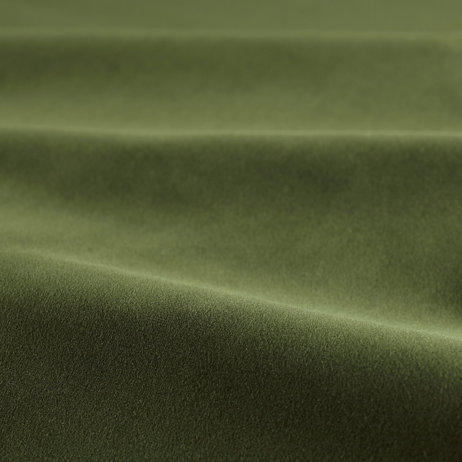 Deep forest green velvet with directional sheen and a softly brushed pile