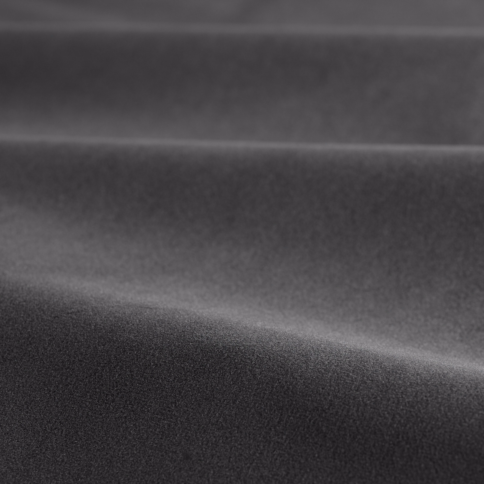 Deep graphite-grey velvet folded to show a soft, subtly reflective pile