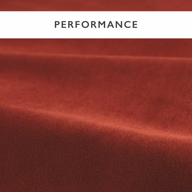 Deep harissa-red velvet with a soft nap and highlighted sheen across folded fabric