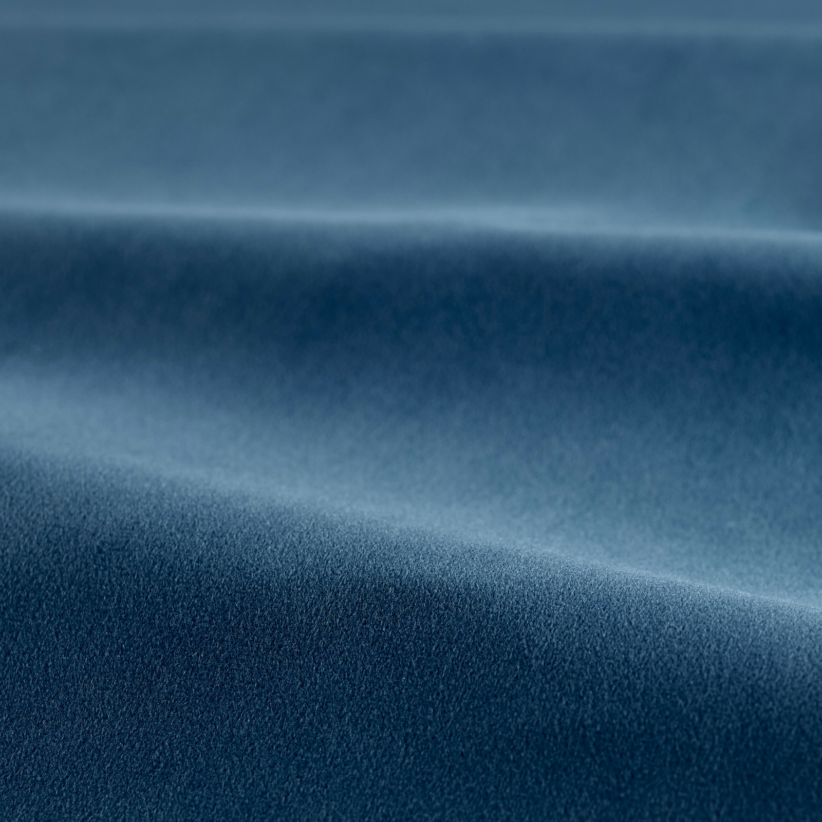 Deep indigo-blue velvet pile with soft highlights across folded fabric