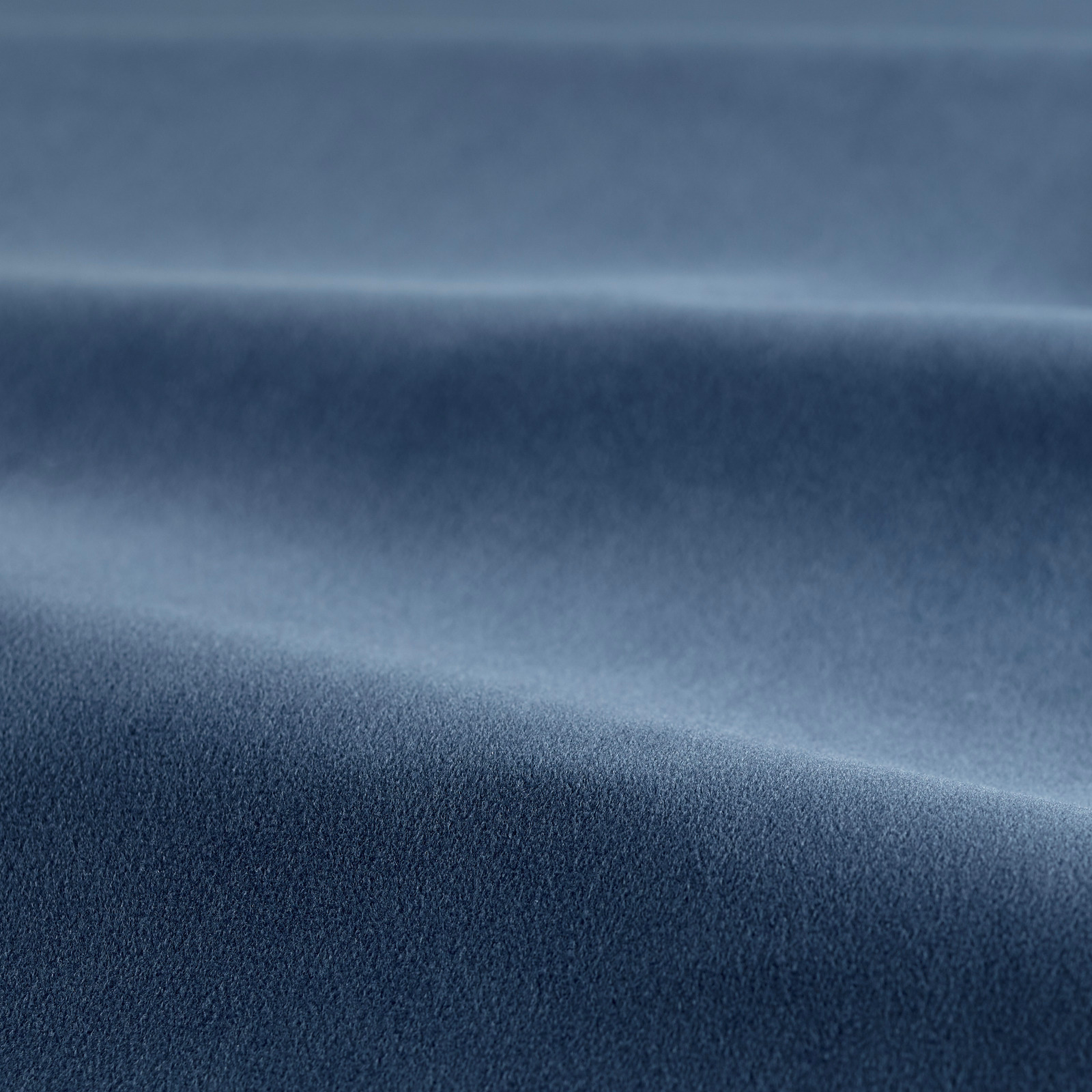 Deep ink-blue velvet with plush pile and pale blue highlights across folded fabric
