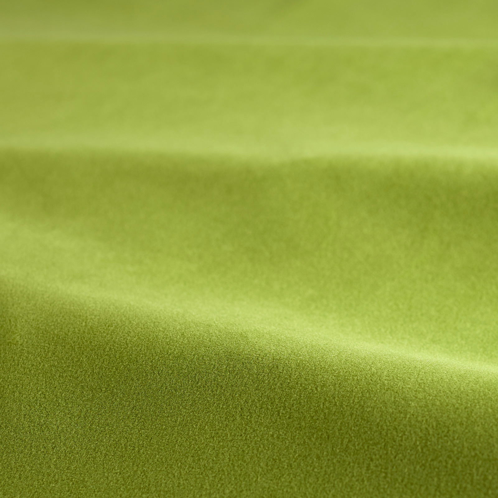 Bright kelp green velvet showing smooth pile and soft directional sheen