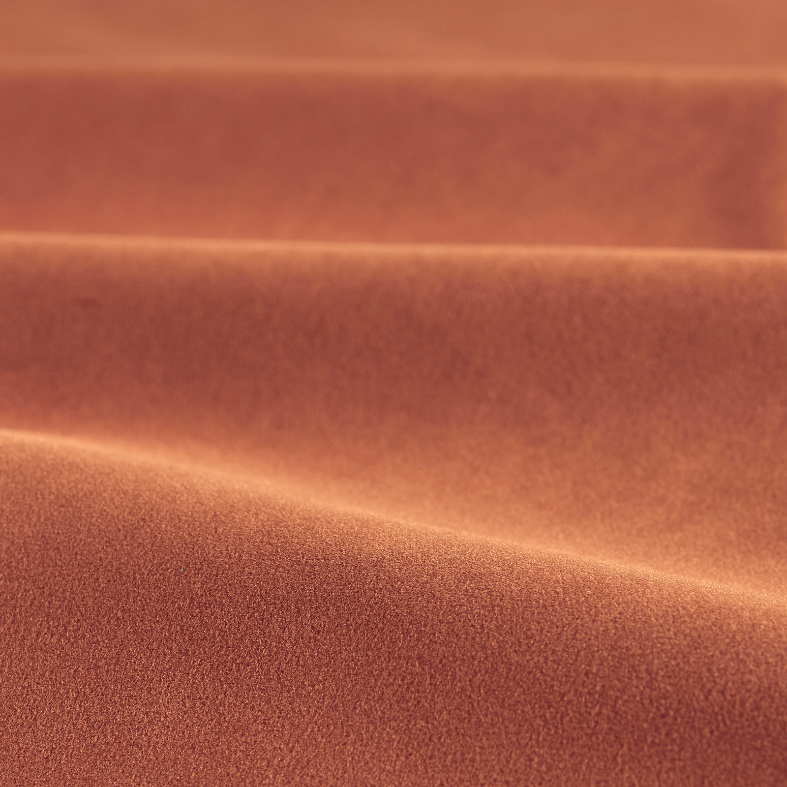 Warm rust velvet with a softly brushed nap and darker folded bands