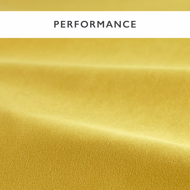 Close-up of warm saffron-gold velvet pile with a softly shifting sheen