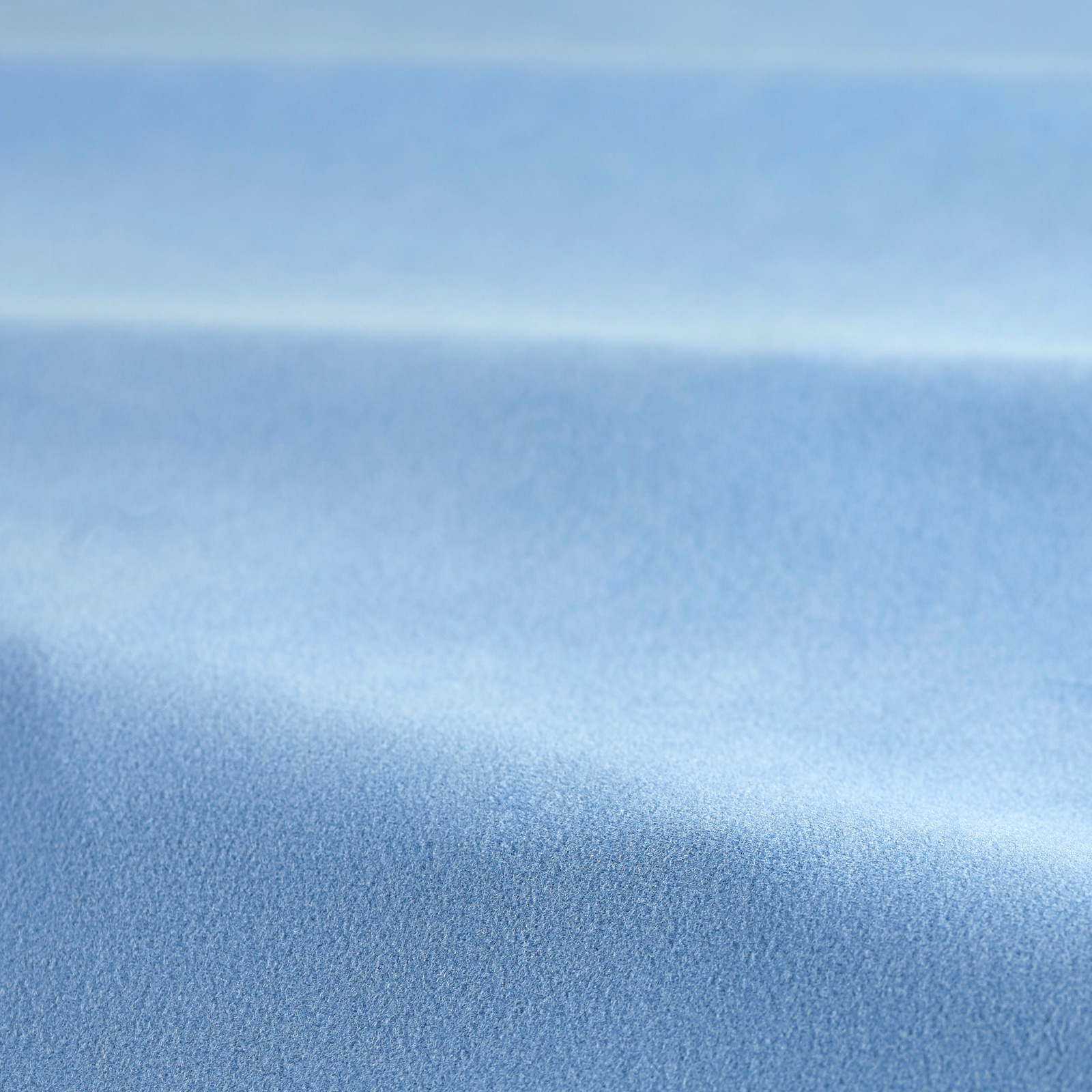 Pale sky blue velvet swatch showing a smooth nap and soft horizontal sheen
