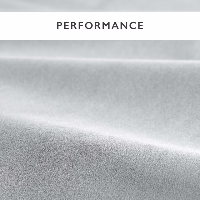 Close-up of cool steel-grey velvet with soft silver highlights across folded pile