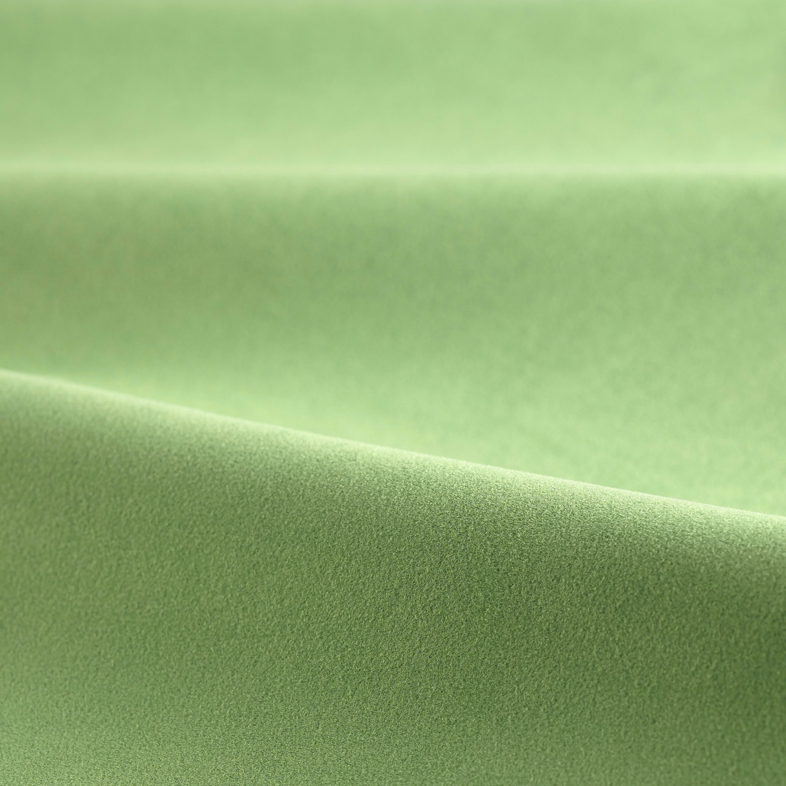 Soft pea-green velvet showing a smooth nap and gentle directional sheen