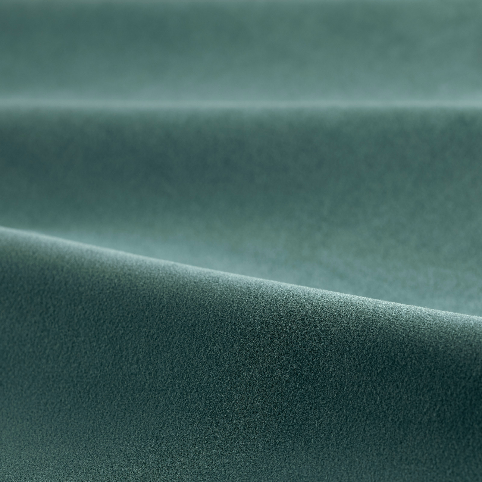 Deep teal velvet pile showing a soft directional sheen across the folded swatch