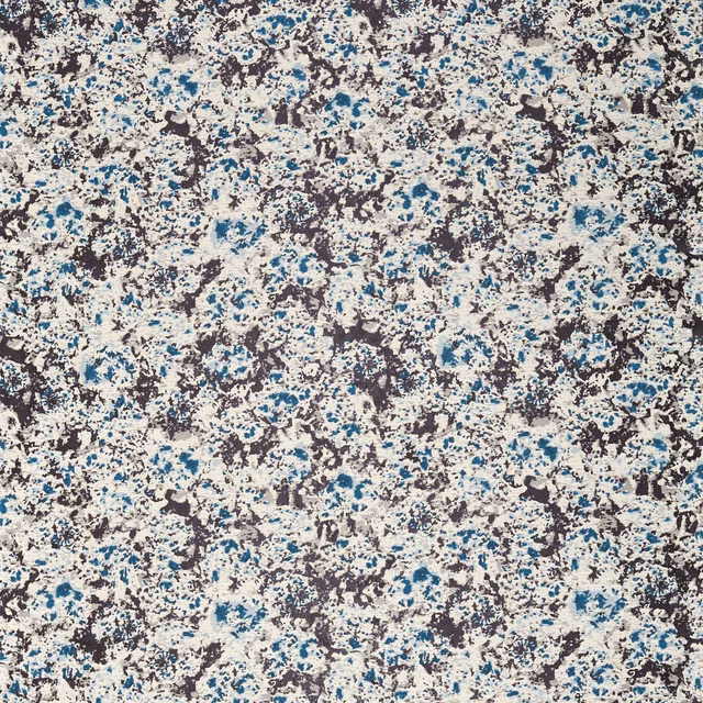 Dense cream textile with ink navy and lapis-blue mottled organic marks