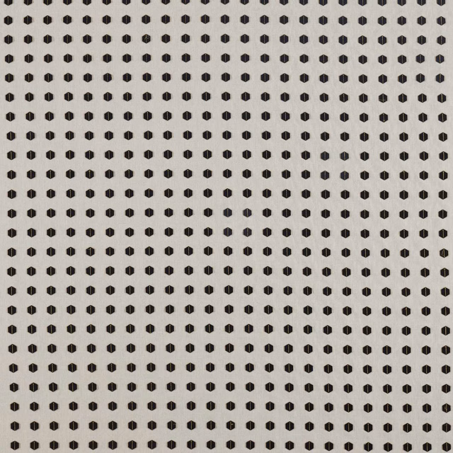 Charcoal geometric dots in a small repeat across a warm gold woven fabric