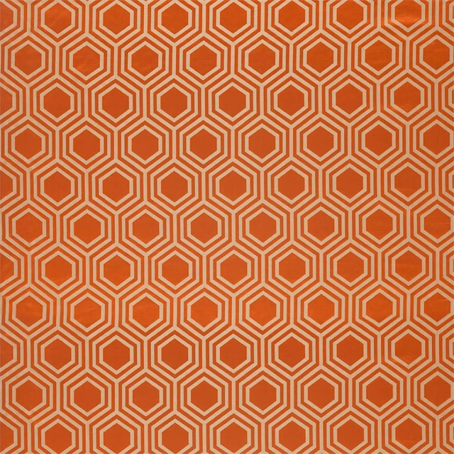 Russet fabric with repeating ivory nested hexagon outlines in a medium geometric pattern