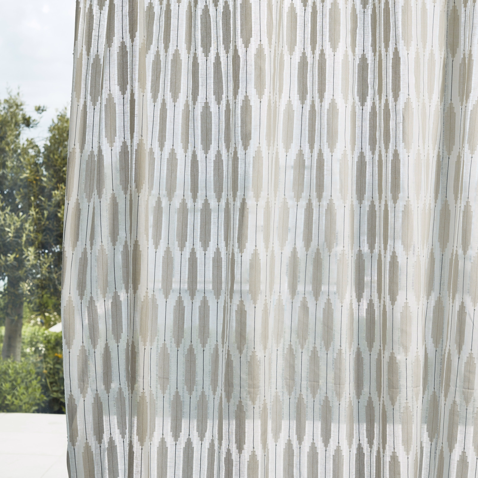 Chalk sheer curtain with pale grey-blue elongated geometric columns in daylight