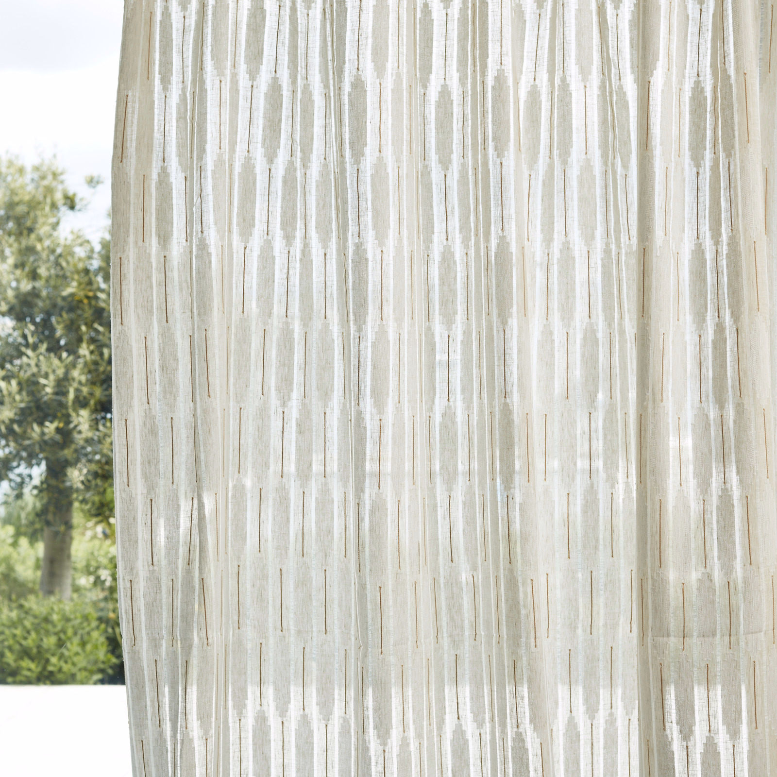 Pale parchment and chalk sheer with irregular vertical striations in window light