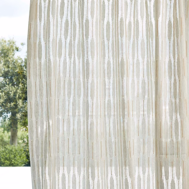 Pale parchment and chalk sheer with irregular vertical striations in window light