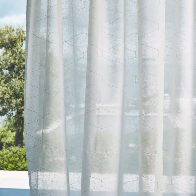 Pale chalk-grey sheer with fine irregular geometric lines in soft daylight