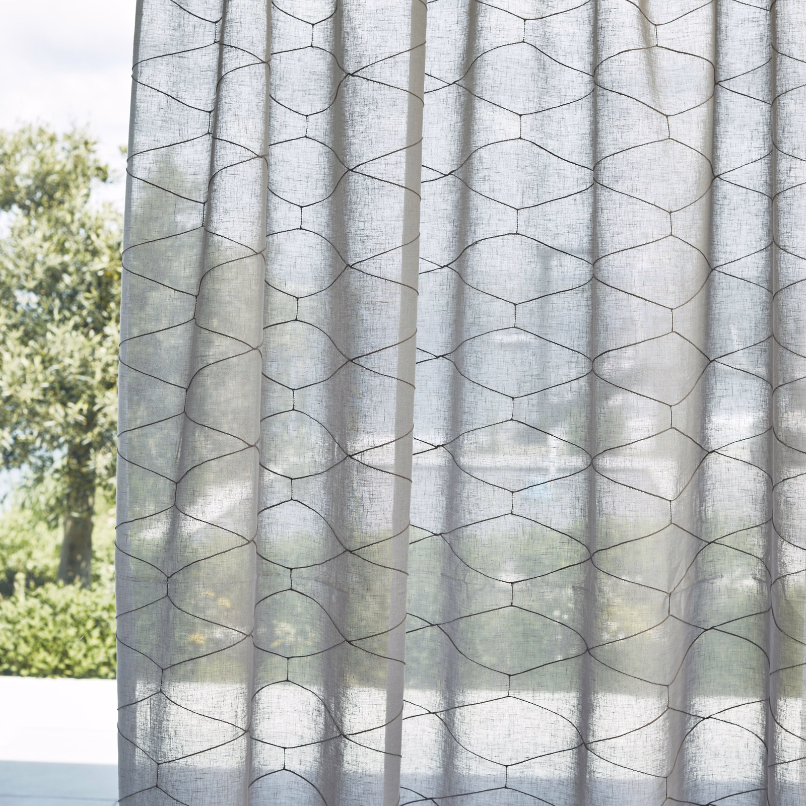 Cool grey sheer curtain with dark irregular hexagonal lines and linen-like texture