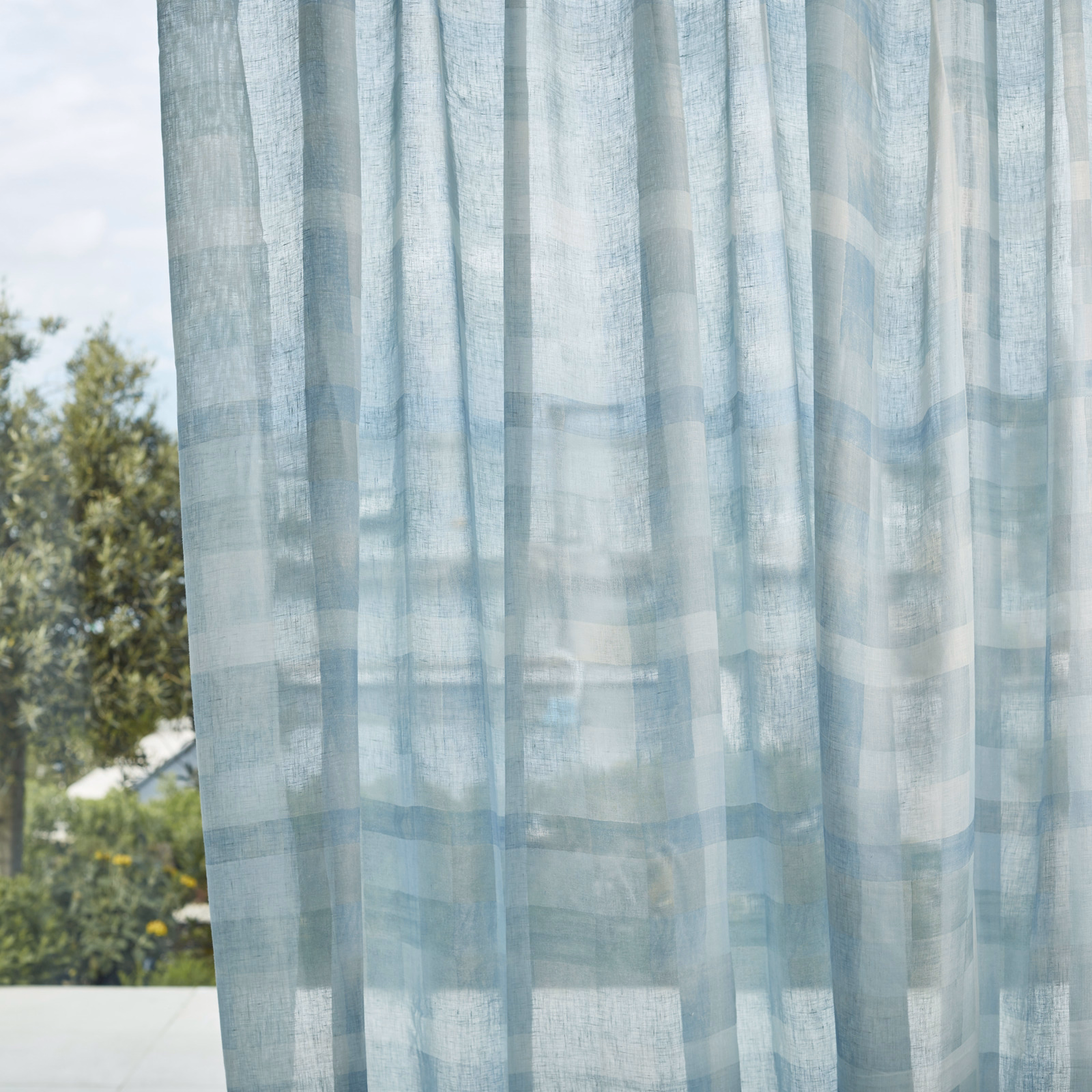 Pale icy-blue sheer with translucent geometric bands and softly textured weave
