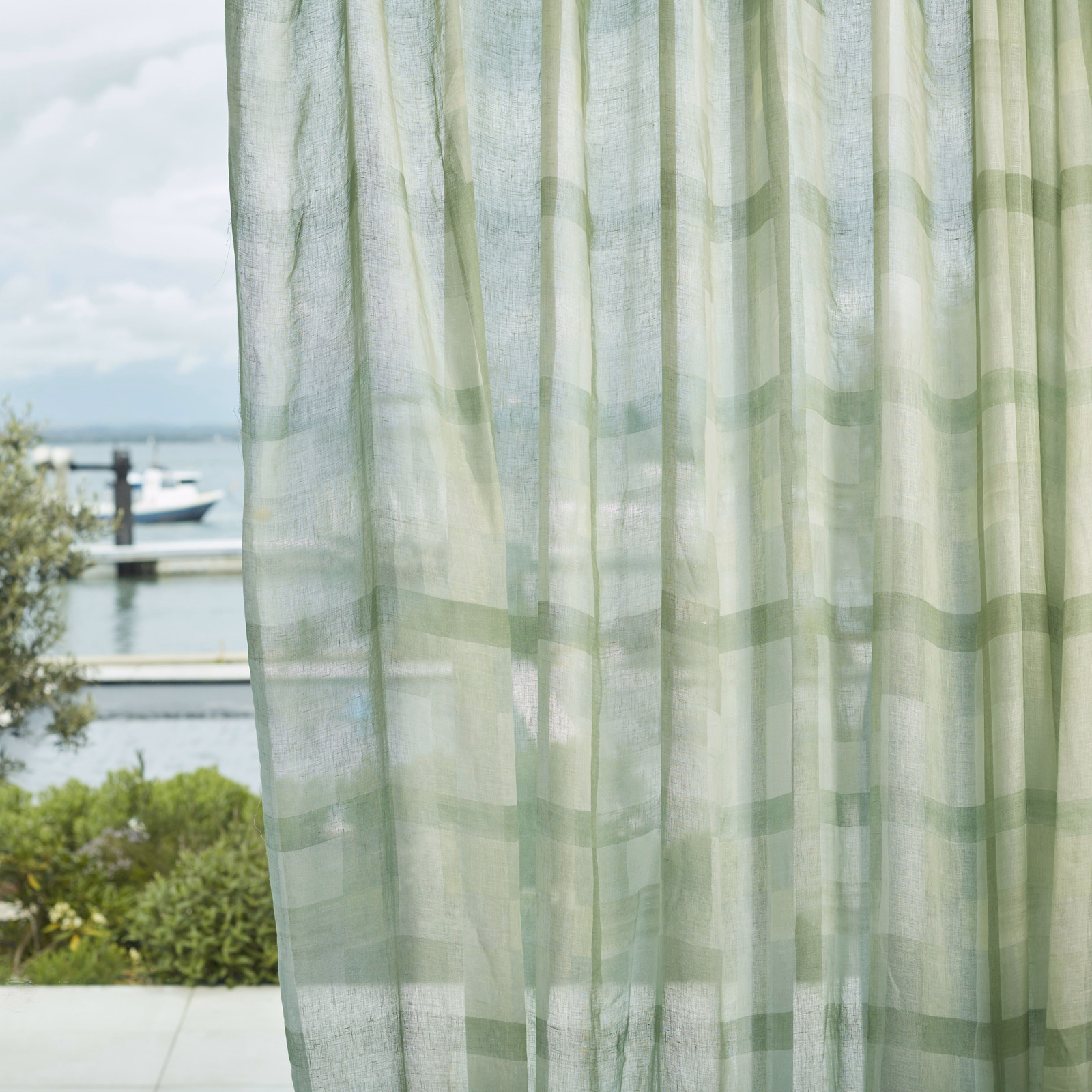 Pale clover-green sheer with translucent blocks and fine vertical woven texture