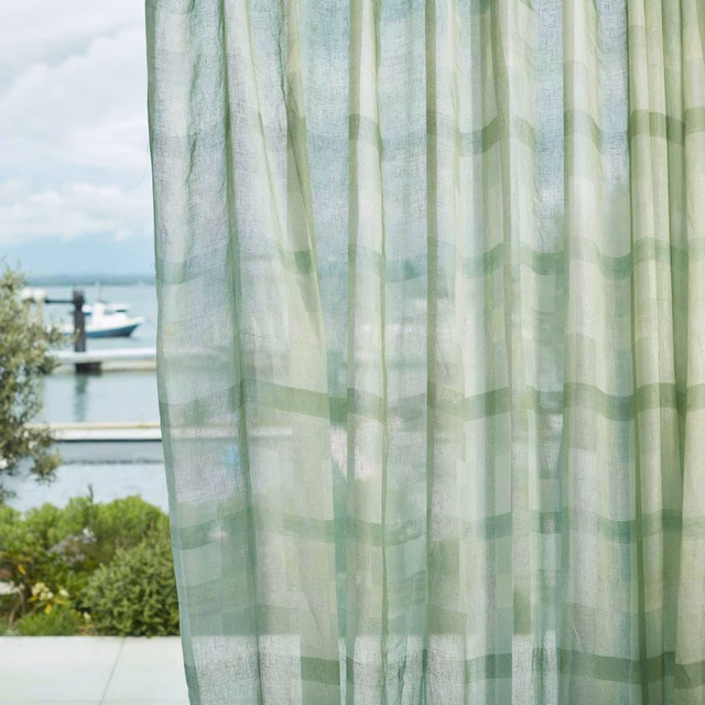 Pale clover-green sheer with translucent blocks and fine vertical woven texture