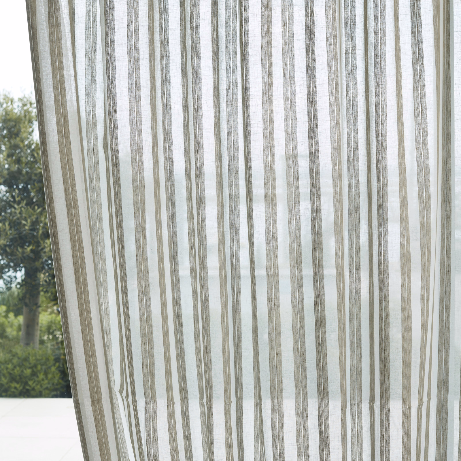 Translucent stone-taupe sheer with irregular vertical grey stripes lit by daylight