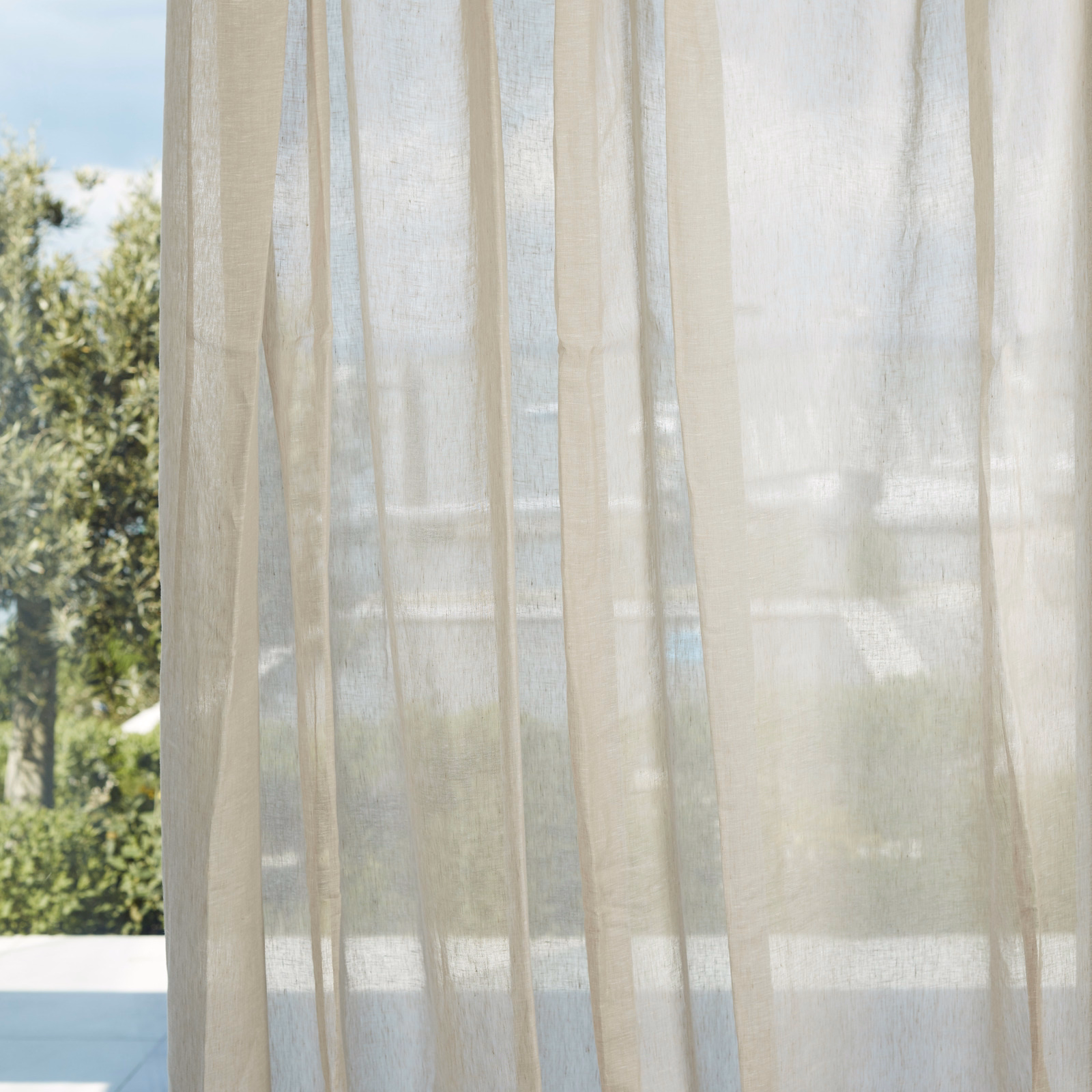 Warm ivory sheer with a fine vertical weave filtering garden light