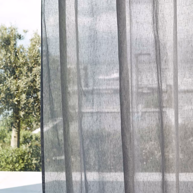 Translucent blue-grey sheer with darker vertical woven bands in daylight