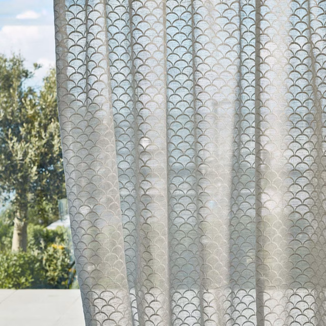 Pale taupe-grey sheer curtain with repeated scalloped arches and translucent folds