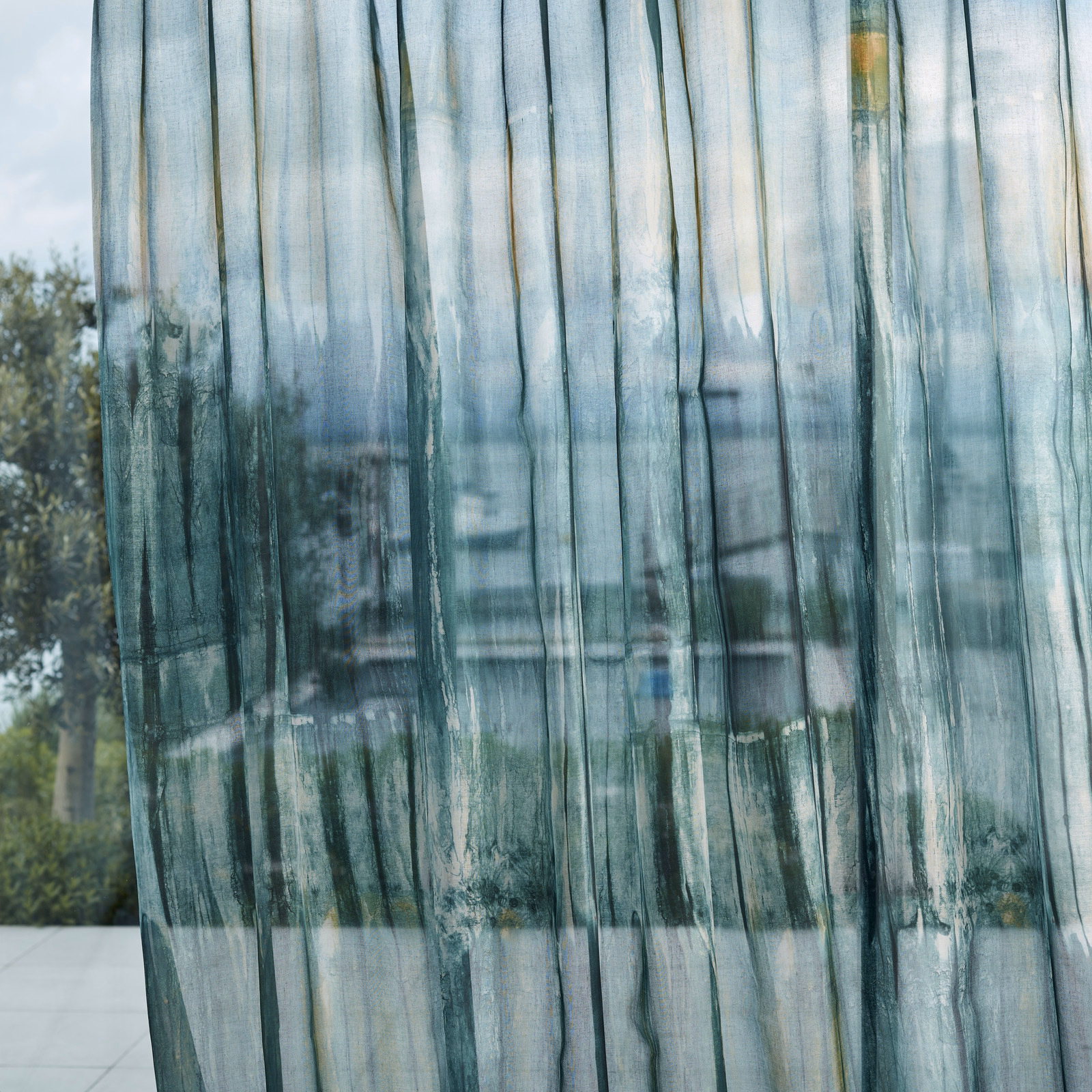 Sheer emerald and stone curtain with vertical painterly striations and saffron glints