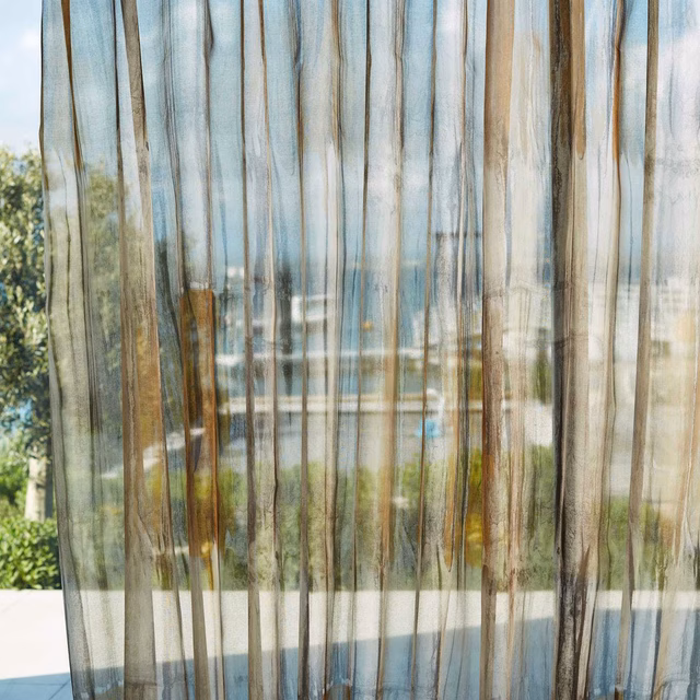 Translucent sheer with saffron, pewter and charcoal vertical striations in sunlight