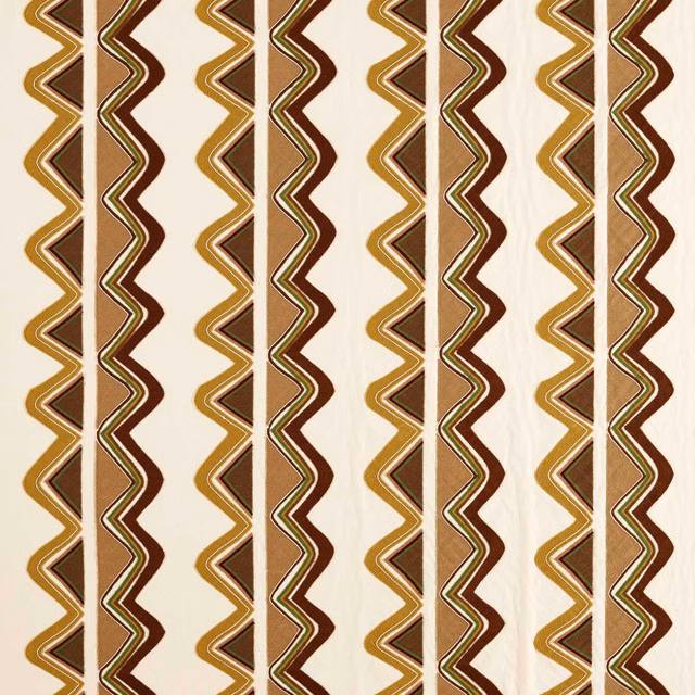 Cream textile with repeating clay, nectar and olive zigzag stripes in woven texture