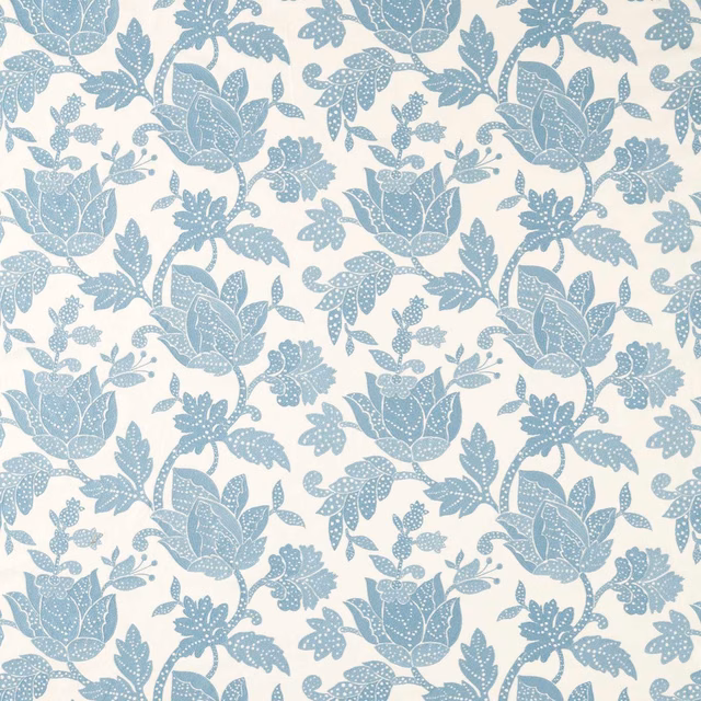Dusty blue floral blooms and dotted leaves on a cream ground