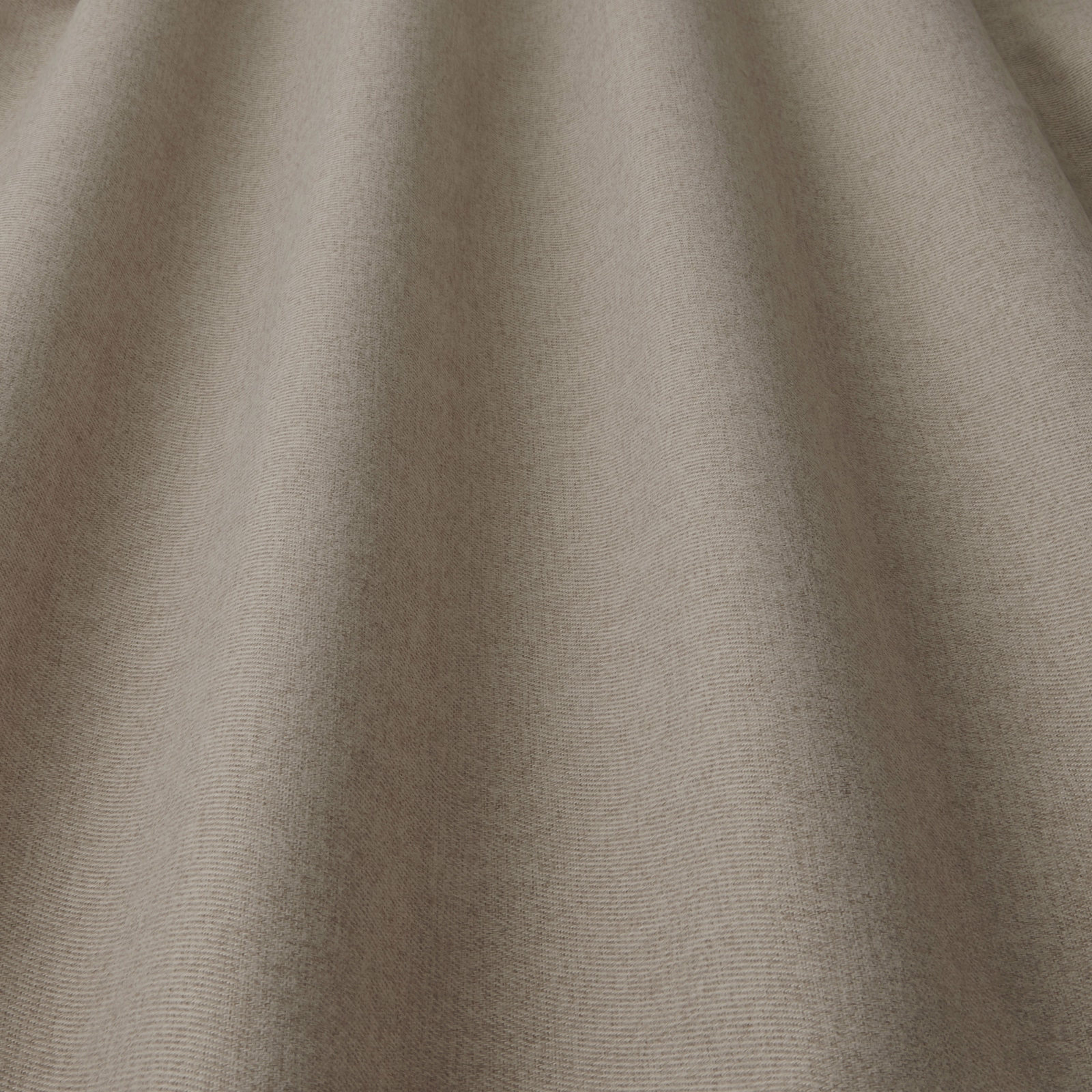 Close-up of warm biscuit beige woven fabric with a soft matte texture
