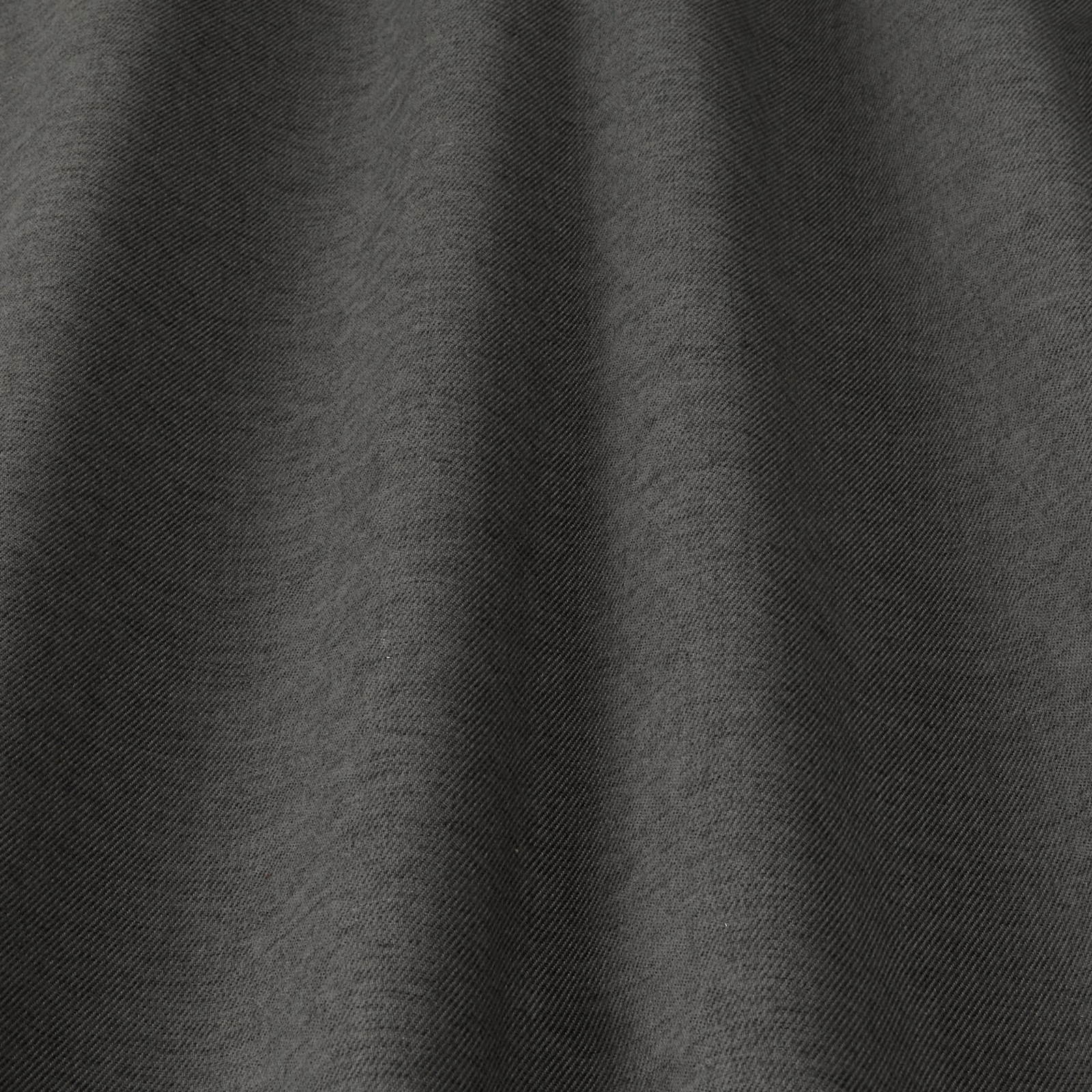 Close-up of deep charcoal grey woven fabric with subtle diagonal texture