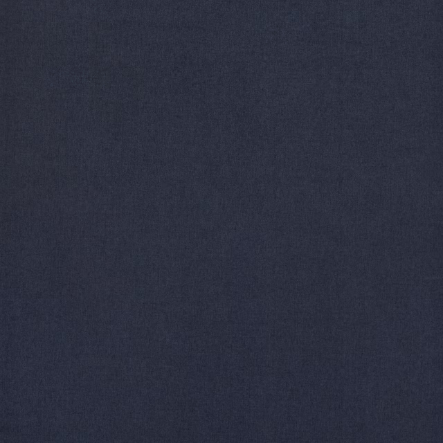 Close-up of deep indigo plain-woven fabric with a fine matte texture