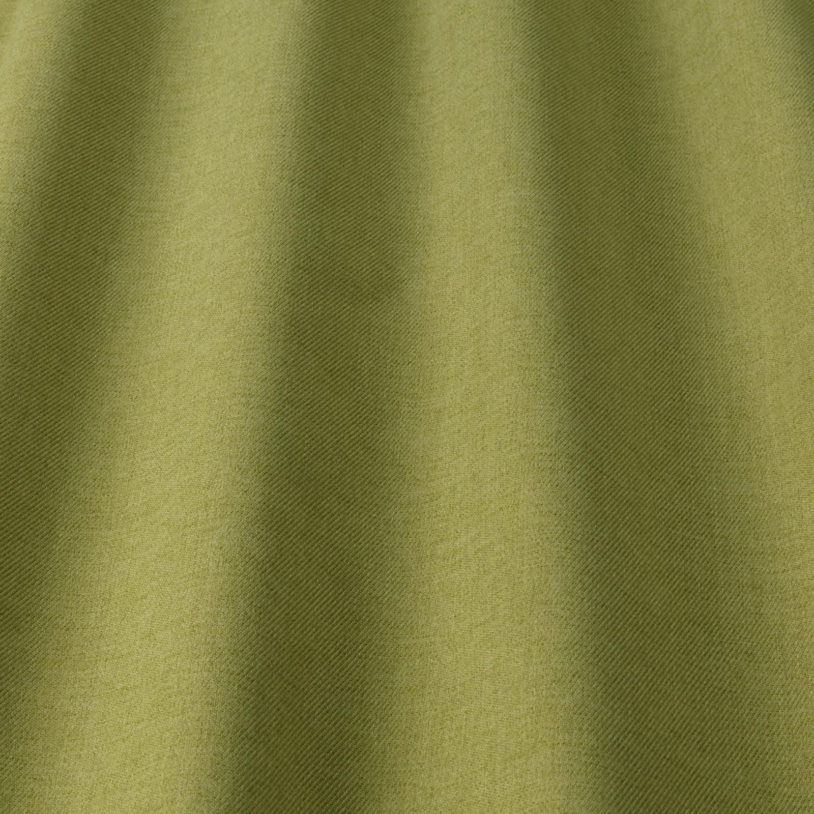 Soft pistachio olive fabric with subtle diagonal weave and gentle shadowed folds