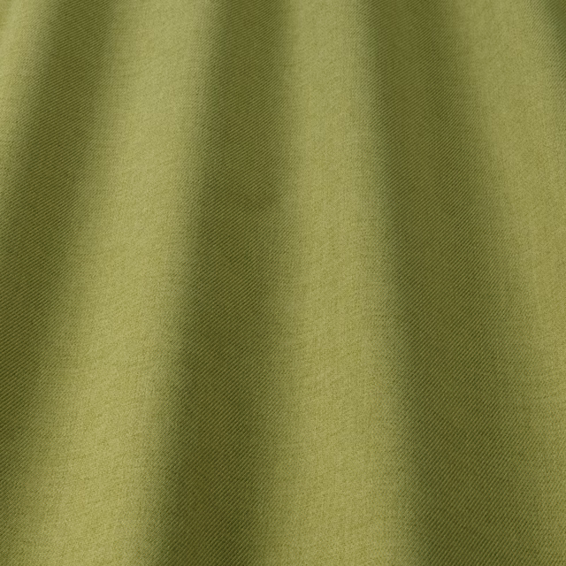 Soft pistachio olive fabric with subtle diagonal weave and gentle shadowed folds