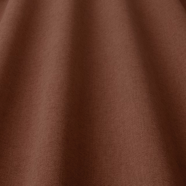 Close-up of warm terracotta-brown woven fabric with soft matte texture