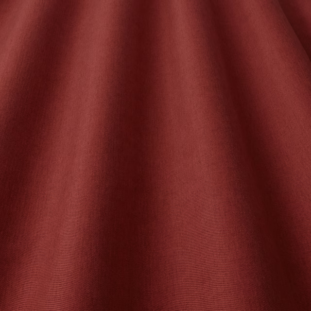 Deep wine-red plain woven fabric with soft folded drape and fine texture
