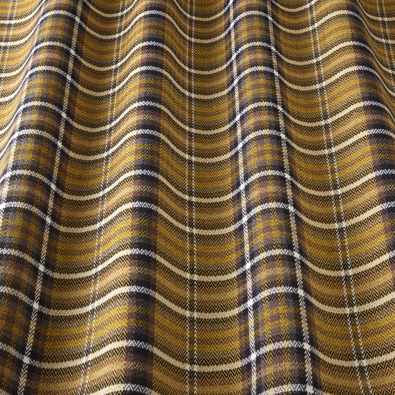Ochre and brown woven check fabric with ivory stripes in soft folds