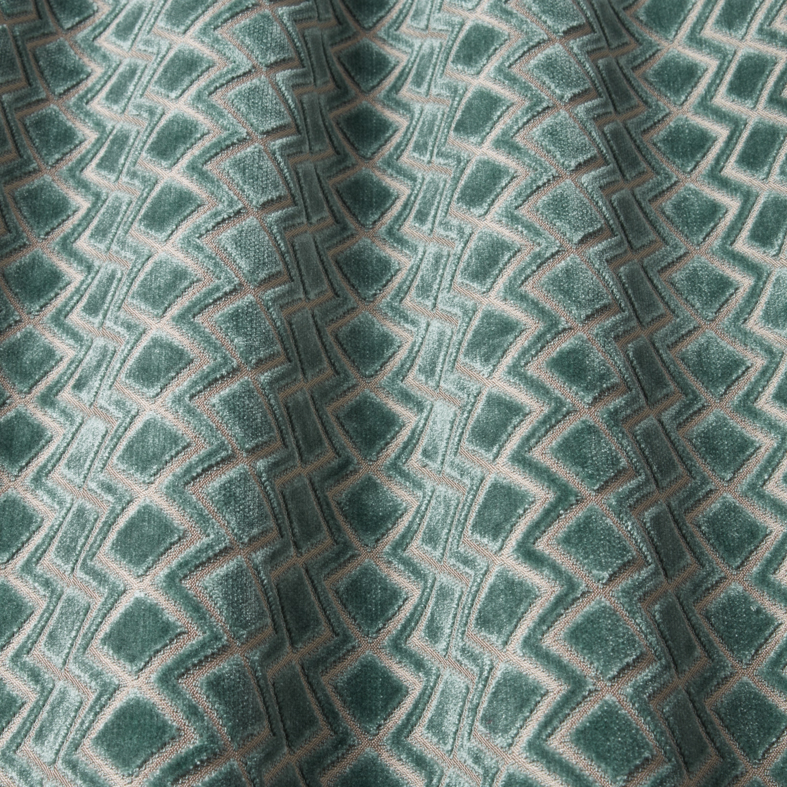 Teal velvet swatch with raised geometric wave pattern and soft sheen