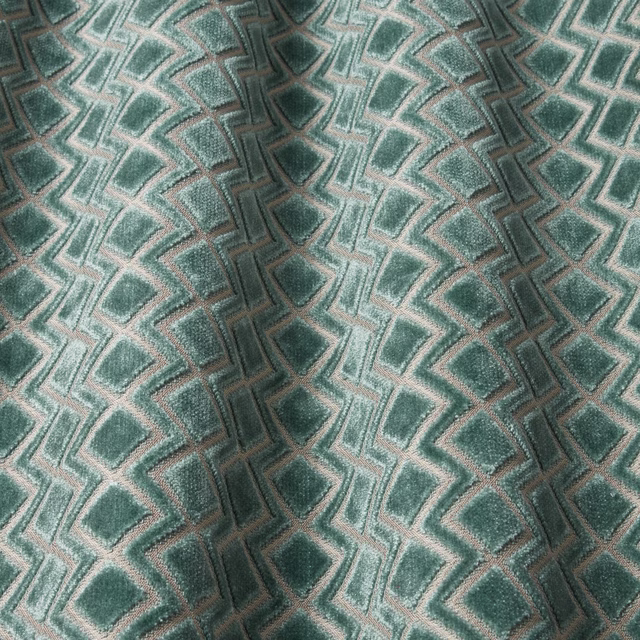 Teal velvet swatch with raised geometric wave pattern and soft sheen